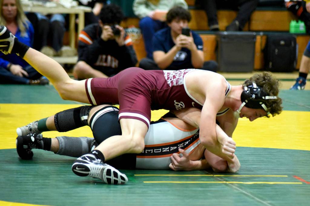 PHOTO BY SUE MICHALAK BUDSBERG Montesanos Finley Ekerson (top) works to earn a pin against Zillahs Quintino Hernandez in the 120-pound title match of The Rock Tournament on Tuesday at Vashon Island High School.