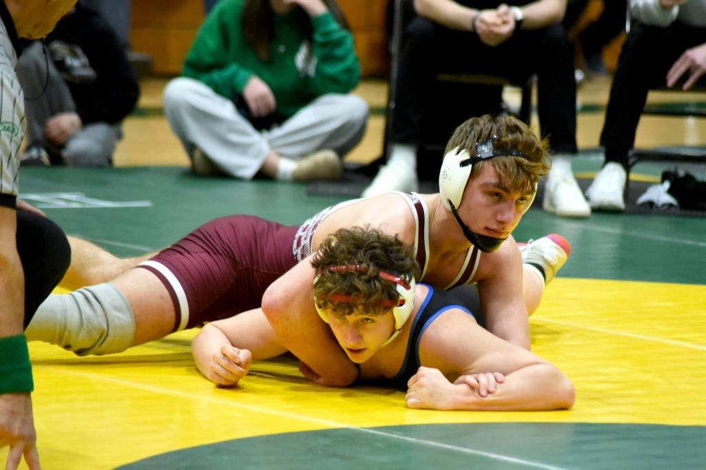 PHOTO BY SUE MICHALAK BUDSBERG Montesanos Gage Stutesman (top) wrestles against East Jeffersons Grady White during the 165-pound championship match of The Rock Tournament on Tuesday at Vashon Island High School.