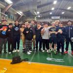 ERICA MCCRORY | MCCRORY PHOTOGRAPHY Aberdeen head coach Jeff Hatton (far left) and his team celebrate a victory at the Battle for the Axe dual-meet tournament on Saturday in Port Angeles. Aberdeen was led by Adonis Hammonds (fourth from left) and Ryder Lessard (holding axe) who each went 4-0 at the meet.
