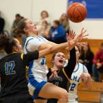 NICOLE SHANNON | MAIN FOCUS MEDIA Elmas Olivia Moore (middle) is fouled during a 63-37 victory over Rochester on Wednesday at Elma High School.