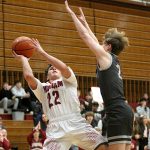 RYAN SPARKS | THE DAILY WORLD Hoquiams K.J. McCoy (22) scores while being fouled by Montesanos Drew Bruland during the Grizzlies 69-64 loss on Thursday at Hoquiam Square Garden.