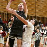 RYAN SPARKS | THE DAILY WORLD Montesanos Mason Fry (left) puts up a shot against Hoquiams Ryan Pullar during the Bulldogs 69-64 victory on Thursday at Hoquiam High School.