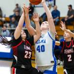 PHOTO BY MIKE ROBERTS Elmas Killie Vest (40) and Teninos Alyssa Brodersen compete for a rebound during the Eagles 61-42 win on Friday in Elma.