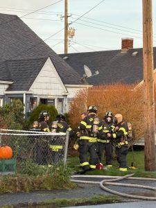 Jerry Knaak / The Daily World 
Aberdeen Fire Department personnel huddle up after extinguishing a house fire on the 2100 block of Aberdeen Avenue in Aberdeen.