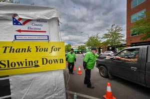 Ron Cooper / Oregon Capital Chronicle 
Jeff Ogg receives a ballot on Monday, May 16, 2022, at a drive-up Marion County ballot drop site in Salem.