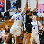 PHOTO BY MIKE ROBERTS Elmas Tyrone Aguilar (24) and North Beachs J.J. Eastman compete for a rebound during the Eagles 66-24 victory on Monday at Elma High School.