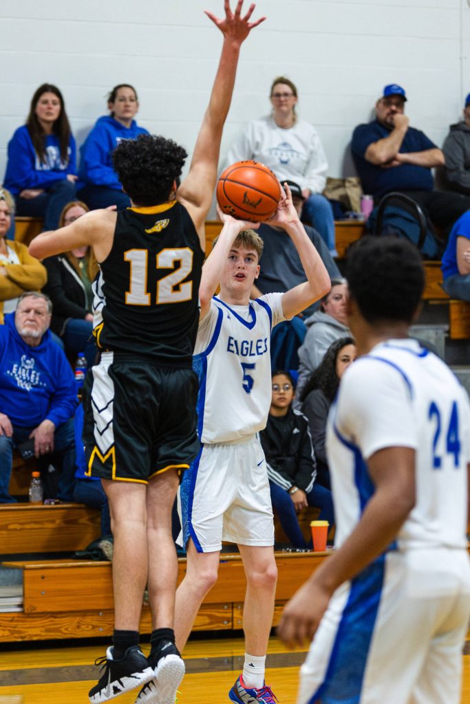 PHOTO BY MIKE ROBERTS Elmas Trey Yeager (5) shoots against North Beachs Jayden Apodaca (12) during the Eagles 66-24 victory on Monday at Elma High School.