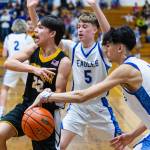 PHOTO BY MIKE ROBERTS Elmas Trey Yeager (5) and Trayton Webb defend against North Beachs Dakota Bryson during the Eagles 66-24 victory on Monday at Elma High School.