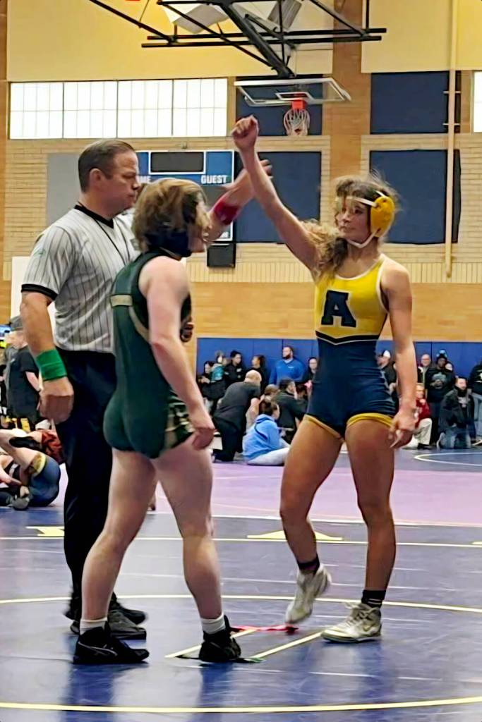 SUBMITTED PHOTO Aberdeens Xela Kowoosh (right) has her hand raised after a win at the Braided 64 girls wrestling tournament on Saturday in Kelso.