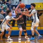 PHOTO BY FOREST WORGUM Aberdeens Xanto Raya (left) and Isaac Garcia strip the ball from W.F. Wests Blake Hampton during the Bobcats 62-51 victory on Tuesday at Aberdeen High School. The win snapped Aberdeens eight-game losing streak to W.F. West.