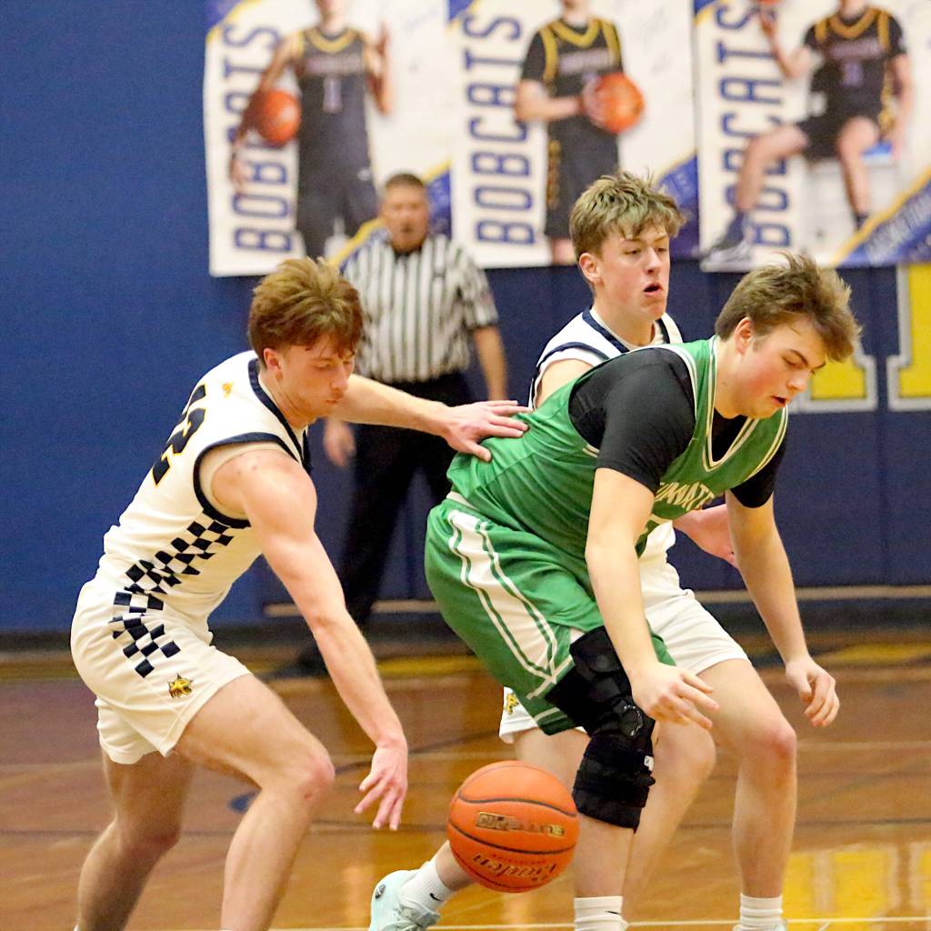 RYAN SPARKS / THE DAILY WORLD 
Aberdeens Gabe Matthews (left) and Ryker Scott force a turnover by Tumwaters Dylan Carroll during the Bobcats 65-48 loss on Thursday at Aberdeen High School.