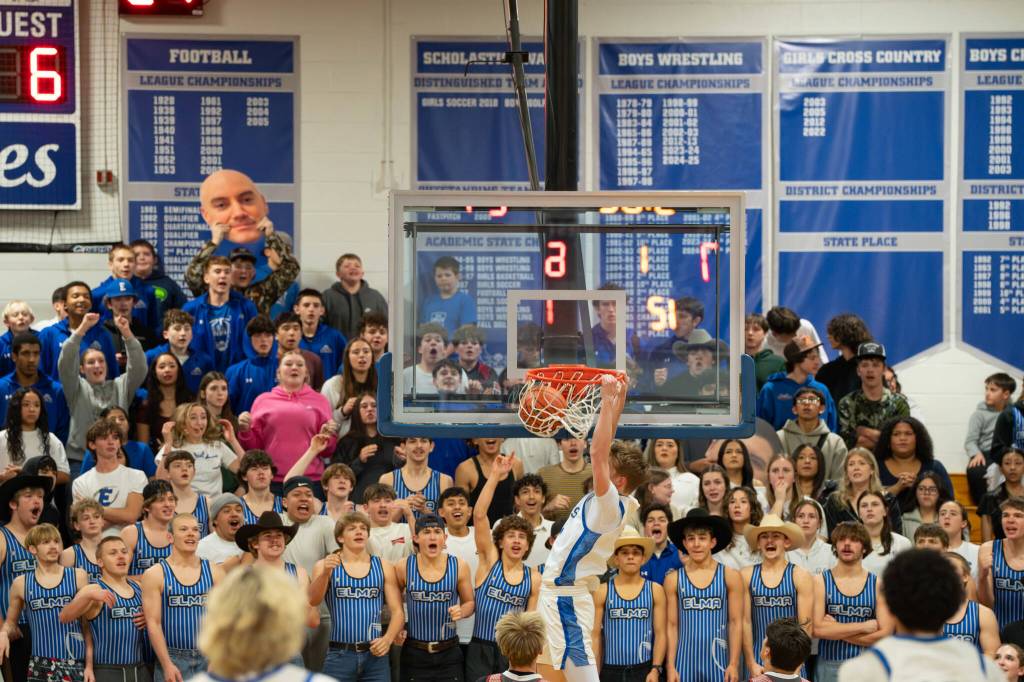 NICOLE SHANNON / MAIN FOCUS MEDIA 
The Elma student section reacts to a slam dunk from Eagles senior Isaac McGaffey during a 52-51 loss to Hoquiam on Thursday in Elma.