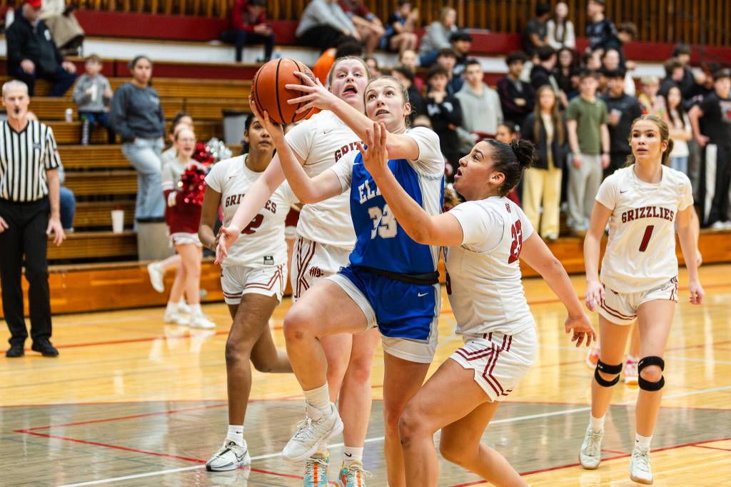 PHOTO BY MIKE ROBERTS Elmas Olivia Moore (left) drives to the hoop while defended by Hoquiams Aaliyah Kennedy during the Grizzlies 55-31 victory on Friday at Hoquiam Square Garden.