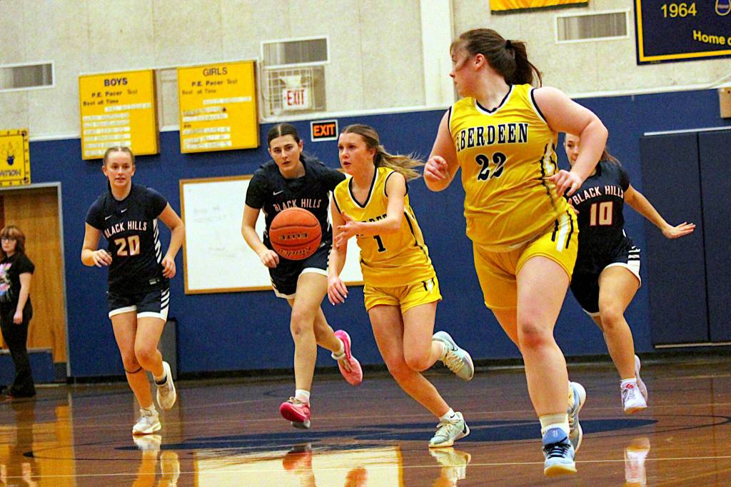 PHOTO BY ADONIS HAMMONDS Aberdeens Sophie Knutson (1) dribbles up the court flanked by teammate Bentley Brown (22) during a 74-41 loss to Black Hills on Tuesday at Aberdeen High School.