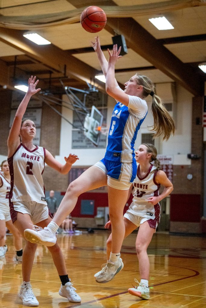 PHOTO BY FOREST WORGUM Elmas Mikayla Roberts (middle) glides toward the basket while defended by Montesanos Jordyn Perry (2) during the Bulldogs 53-43 win on Tuesday at Montesano High School.
