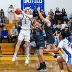 PHOTO BY MIKE ROBERTS Elma guard Tanner Moe (2) grabs a rebound against Montesanos Ryan Weidman (12) and Caden Grubb during the Eagles 60-44 win on Wednesday at Elma High School.