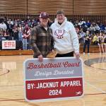 RYAN SPARKS | THE DAILY WORLD Christian Burgess (left) poses for a photo with Hoquiam school board member Tanya Anderson after Burgess was honored as a Hoquiam Hometown Hero ahead of the Aberdeen-Hoquiam boys basketball game on Thursday at Hoquiam High School.