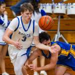 PHOTO BY MIKE ROBERTS Elmas Isaac McGaffey (3) grabs a loose ball during a 68-37 victory over Rochester on Friday at Elma High School.