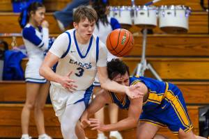 PHOTO BY MIKE ROBERTS Elmas Isaac McGaffey (3) grabs a loose ball during a 68-37 victory over Rochester on Friday at Elma High School.