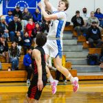 PHOTO BY MIKE ROBERTS Elma senior Isaac McGaffey soars to the basket to score two of his game-high 22 points in a 66-28 win over Tenino on Wednesday in Elma.