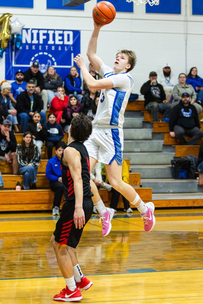 PHOTO BY MIKE ROBERTS Elma senior Isaac McGaffey soars to the basket to score two of his game-high 22 points in a 66-28 win over Tenino on Wednesday in Elma.