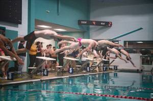 ALICIA TISDALE | ALICIA TISDALE PHOTOGRAPHY Competitors leap into the pool at the start of a relay race between Aberdeen and Shelton at a swim meet on Wednesday in Hoquiam.