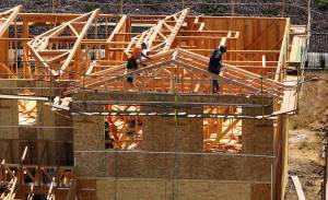 Justin Sullivan / Getty Images / TNS
In an aerial view, construction workers build a home at a new housing development in Richmond, California.