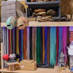 Glove lacing leather in a variety of colors hangs from the wall of KTMK Gloves founder Ken Ervins garage workshop.