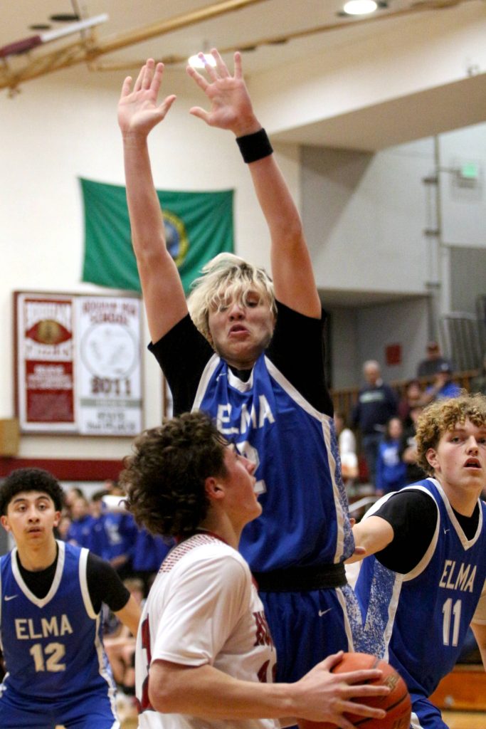 RYAN SPARKS | THE DAILY WORLD Elma guard Tanner Moe (top) defends against Hoquiams K.J. McCoy during the Eagles 60-59 overtime loss on Wednesday at Elma High School.