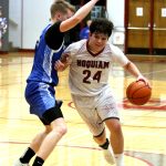 RYAN SPARKS | THE DAILY WORLD Hoquiam guard Lincoln Niemi (24) dribbles against Elmas Isaac McGaffey during the Grizzlies 60-59 overtime win on Wednesday at Hoquiam Square Garden.