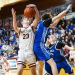 PHOTO BY MIKE ROBERTS Montesanos Caden Grubb (23) snags a rebound against Elmas Trey Yeager during the Bulldogs 54-32 victory on Friday in Montesano.