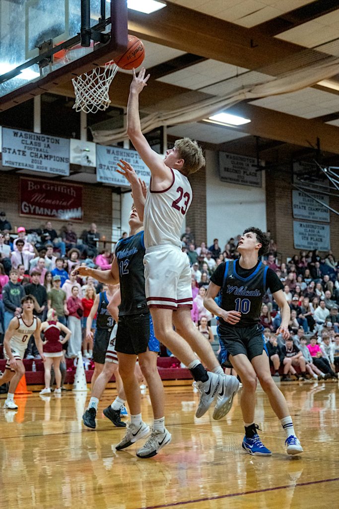 PHOTO BY FOREST WORGUM Montesanos Caden Grubb (23) scores two of his 18 points during a 75-56 win over La Center in a 1A District 4 Tournament game on Thursday in Montesano.