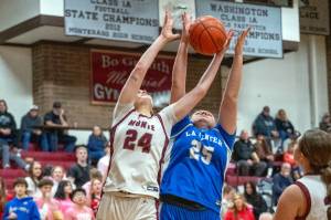 PHOTO BY FOREST WORGUM Montesanos Jillie Dalan (24) and La Centers Kimber Kennedy reach for a rebound during the Bulldogs 53-26 win in a 1A District 4 Tournament game on Thursday in Montesano.