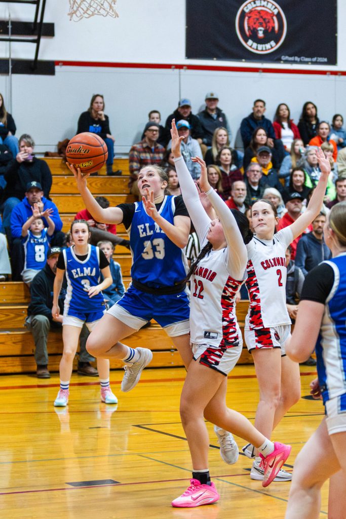 PHOTO BY MIKE ROBERTS Elma senior Olivia Moore (33) drives to the hoop against Columbia (White Salmon)s Claira Camacho during the Eagles 44-43 loss in a 1A District 4 Tournament game on Friday at Columbia High School.