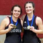 SUBMITTED PHOTO Hoquiams Meribel Mazariegos (left) and Emily Brodhead pose with their district-championship medals at the WIAA District 4 Girls 1B/2B/1A Tournament on Saturday at Montesano High School.