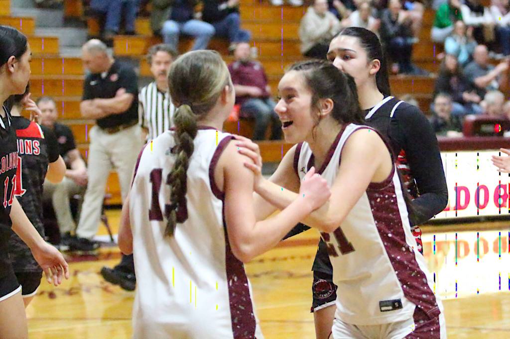 RYAN SPARKS | THE DAILY WORLD Montesanos Makena Blancas (21) celebrates with Ashlyn Lytle after Lytle scored and was fouled during the first quarter of Montesanos 38-27 victory over Columbia (White Salmon) in a 1A District 4 semifinal game on Wednesday in Montesano.