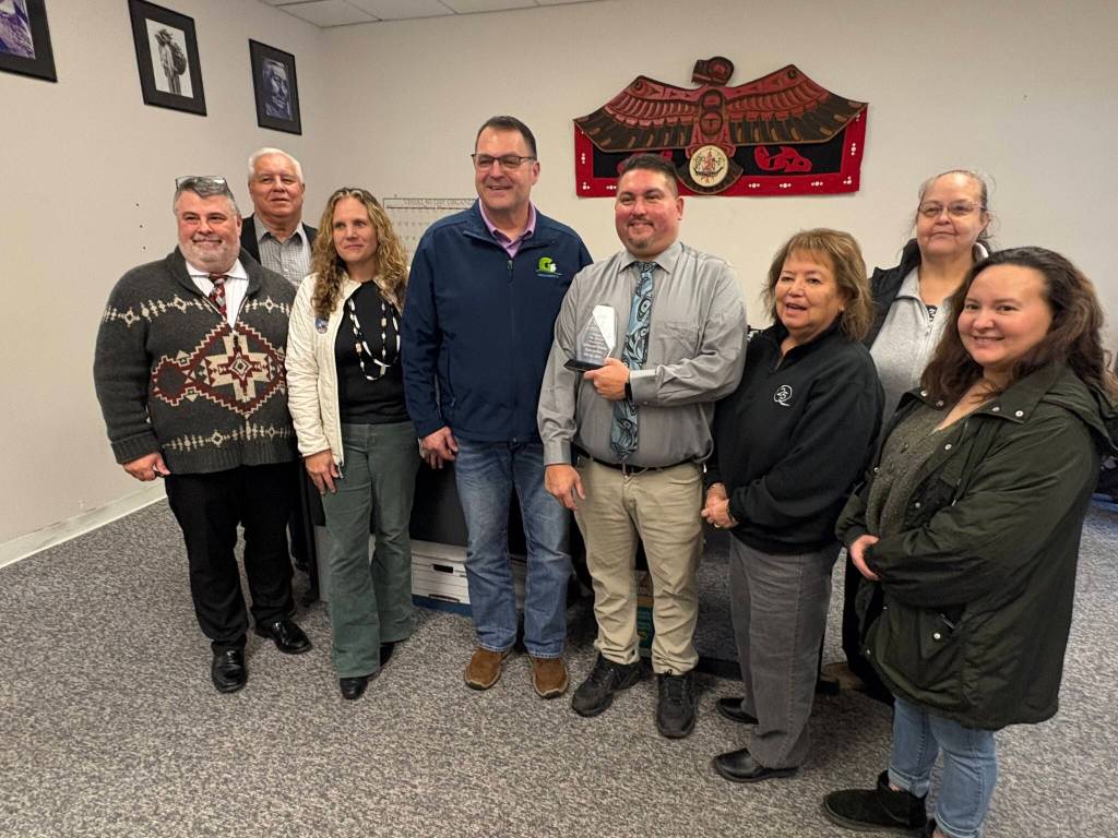 Jerry Knaak / The Daily World
Greater Grays Harbor, Inc. CEO Darrin Raines poses for a photo with members of Quinault Nation Enterprises.