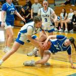 NICOLE SHANNON | MAIN FOCUS MEDIA Elmas Olivia Moore (left) and La Centers Lillian Cosmi battle for a loose ball during the Eagles 48-34 victory in a 1A District 4 elimination game on Wednesday at Elma High School.