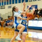 NICOLE SHANNON | MAIN FOCUS MEDIA Elmas Olivia Moore (left) drives the lane during a 48-34 victory over La Center in a 1A District 4 elimination game on Wednesday at Elma High School.