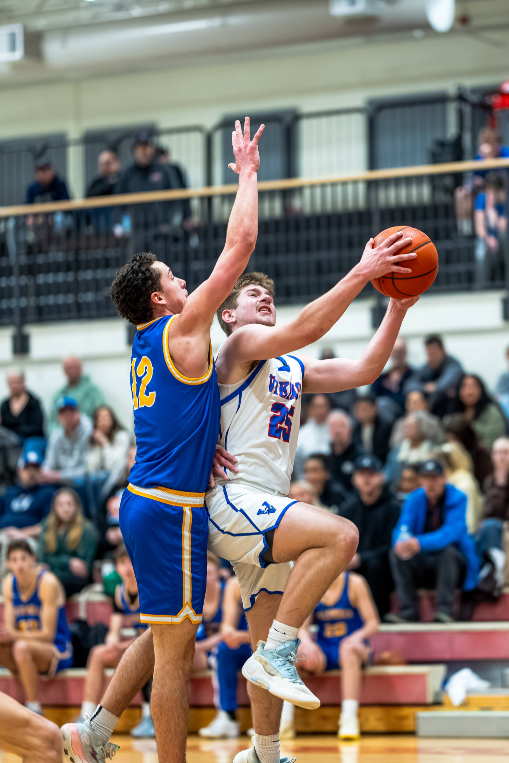 PHOTO BY MATT RUMBLES Willapa Valleys Max Jarvis (25) drives to the rim against Columbia Adventists Luke Pierce during the Vikings 60-46 win in a 1B District 4 semifinal game on Wednesday in Toledo.