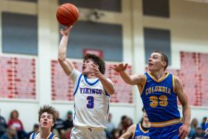 PHOTO BY MATT RUMBLES Willapa Valleys Blane King (3) puts up a shot against Columbia Adventists Tristan White during the Vikings 60-46 victory in a 1B District 4 semifinal game on Wednesday at Toledo High School.