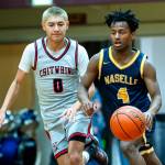PHOTO BY MATT RUMBLES Taholah guard Hunter Crossguns (0) defends Naselles Gus Burkhalter during the Chitwhins 64-59 victory in a 1B District 4 elimination game on Friday at Raymond High School.
