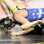 PHOTO BY SUE MICHALAK BUDSBERG Elmas Xavier Espinoza (top) works to pin Vashon Islands Taevin Gilbert during a 132-pound match at the Mat Classic XXXVII on Friday at the Tacoma Dome. Espinoza won his second-consecutive state championship on Saturday.