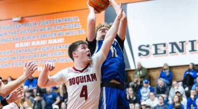 PHOTO BY MIKE ROBERTS 
Elmas Gavin Muir (11) shoots while defended by Hoquiams Joey Bozich during the Eagles 70-67 win in a 1A District 4 elimination game on Saturday in Centralia.