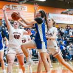 PHOTO BY MIKE ROBERTS 
Elmas Olivia Moore (middle) drives to the hoop against Hoquiams Sydney Gordon (42) and Mikalah Haskey during the Grizzlies 35-32 victory in a 1A District 4 elimination game on Saturday at Centralia High School.