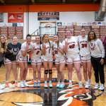 Hoquiam head coach Chad Allan (far right) and his Grizzlies pose for a photo after securing a berth in the 1A State Tournament with a 35-32 win over Elma in a 1A District 4 elimination game on Saturday at Centralia High School.