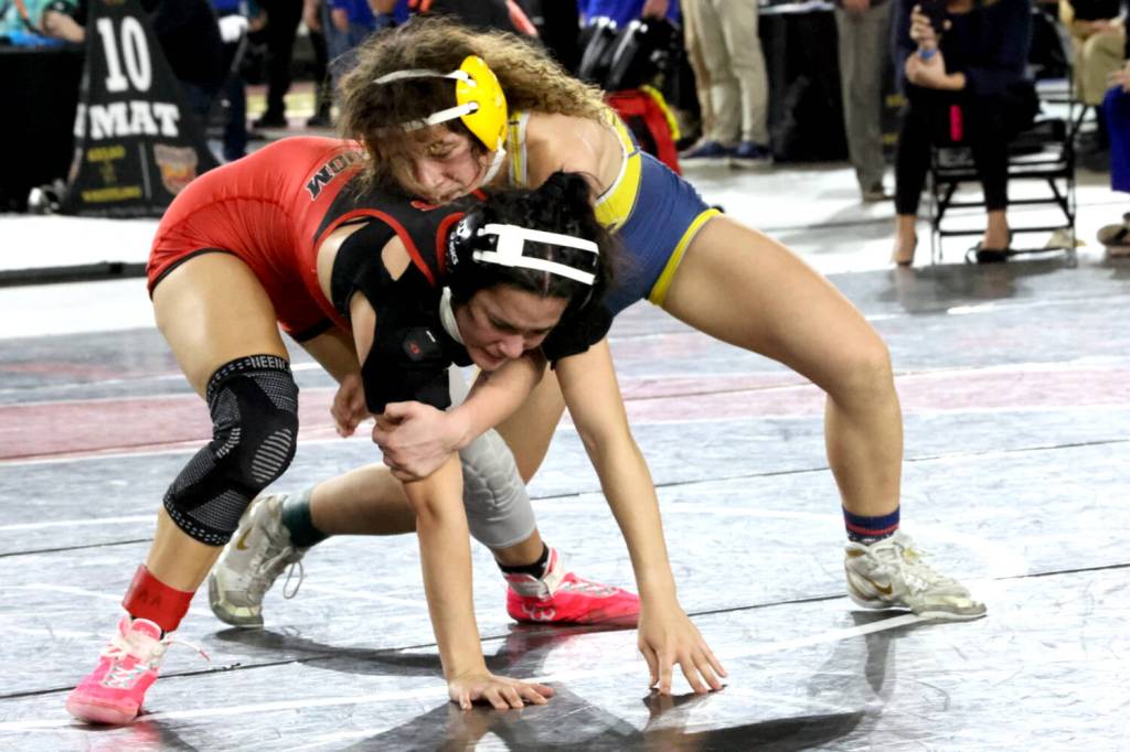 ERICA MCCRORY | MCCRORY PHOTOGRAPHY Aberdeen freshman Xela Kowoosh (top) controls Steliacooms Nadia Winn during the 2A 125-pound state-championship match at the Mat Classic XXXVII on Saturday at the Tacoma Dome.