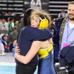 ERICA MCCRORY | MCCRORY PHOTOGRAPHY Aberdeens Xela Kowoosh get a hug from Bobcats assistant coach Tamar Yakovich (left) while head coach Craig Yakovich looks on after winning the 2A 125-pound state championship at the Mat Classic XXXVII on Saturday in Tacoma.