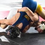 PHOTO BY SUE MICHALAK BUDSBERG Wearing the singlet previously worn by his older brother Cole, Montesanos Finley Ekerson (background) defeated Wapatos Xzavier Garza 4-0 to win the 1A 120-pound state championship at the Mat Classic XXXVII on Saturday at the Tacoma Dome.