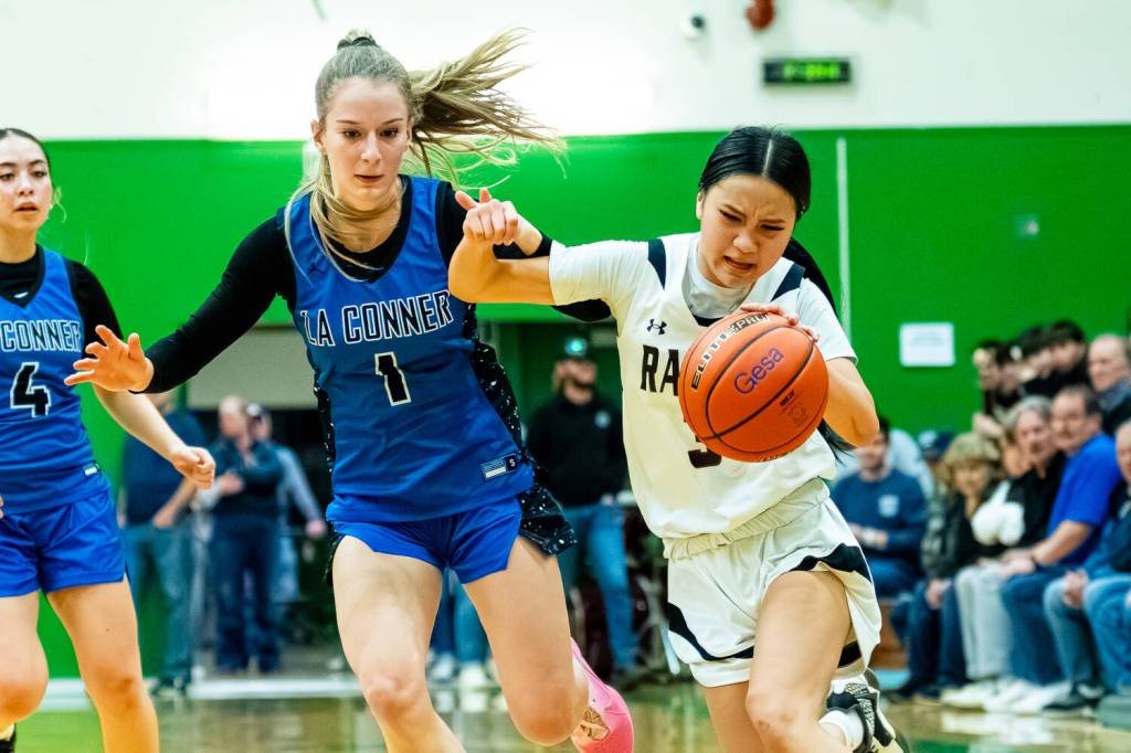 PHOTO BY MATT RUMBLES 
Raymond-South Bends Megan Kongbouakhay (right) fights off La Conner defender Maeve McCormick during the Ravens 50-40 win in a 2B State Tournament first-round game on Saturday at Tumwater High School.